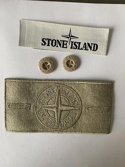 Beige stone island badge