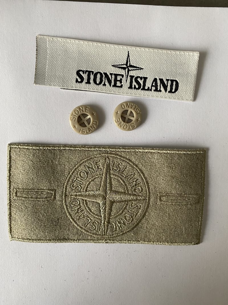 beige stone island badge